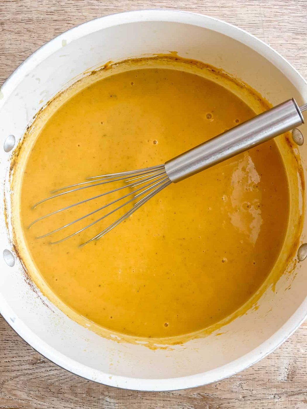 Sweet potato pumpkin soup being whisked.