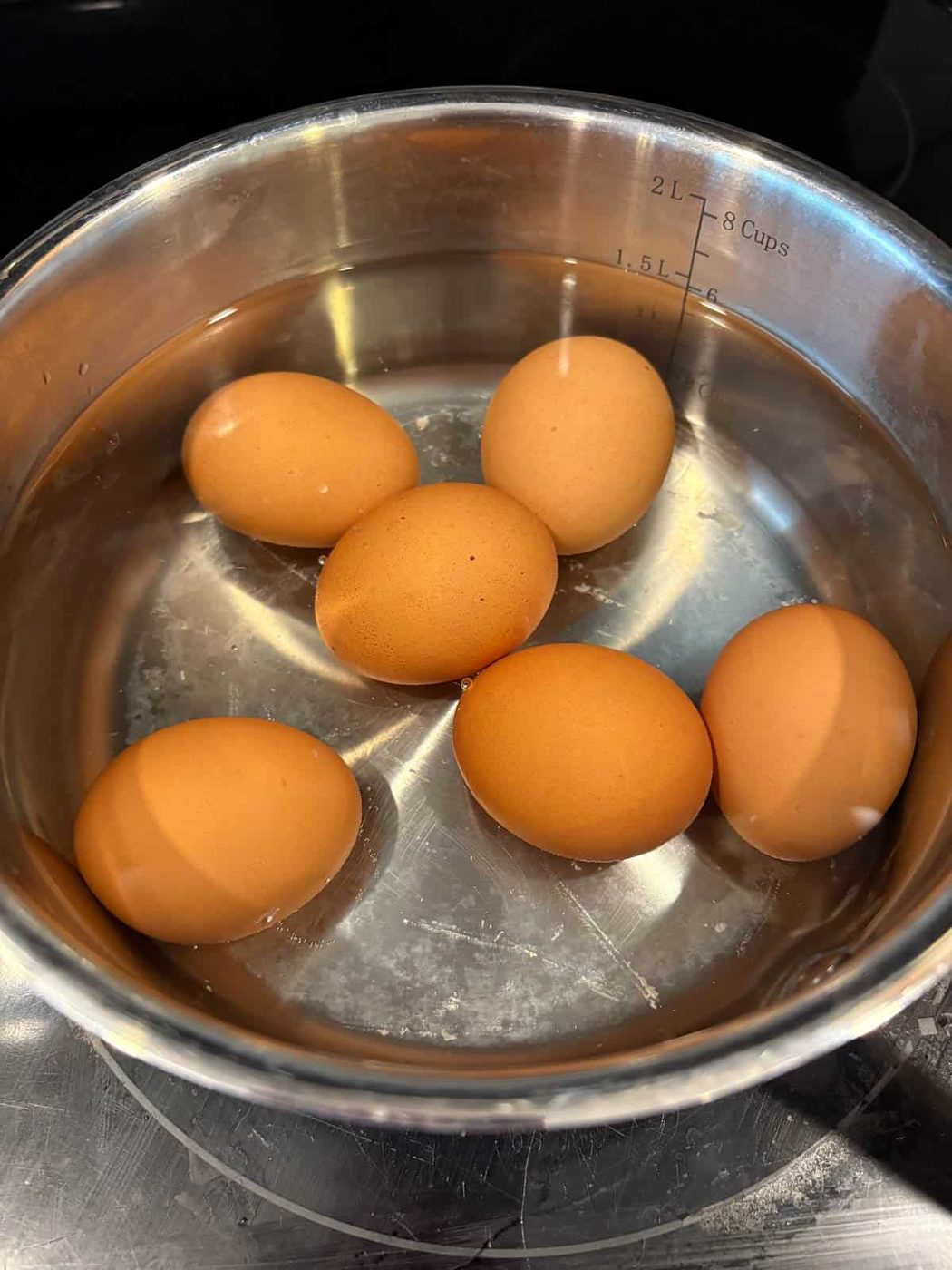 Eggs boiling in a pan.