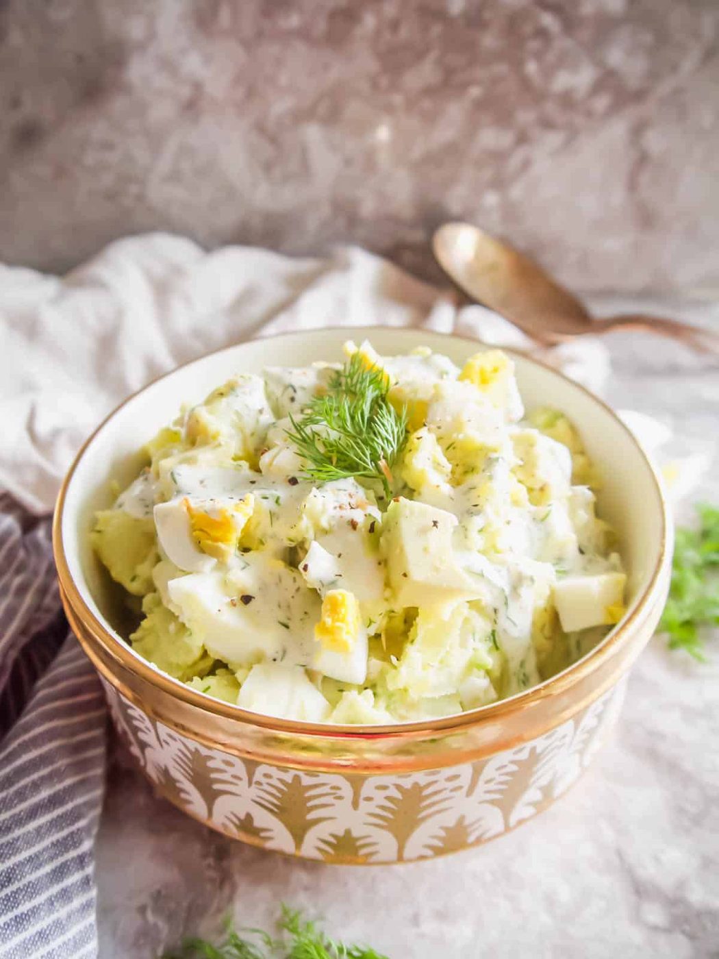 From-scratch egg potato salad with avocado in a bowl.