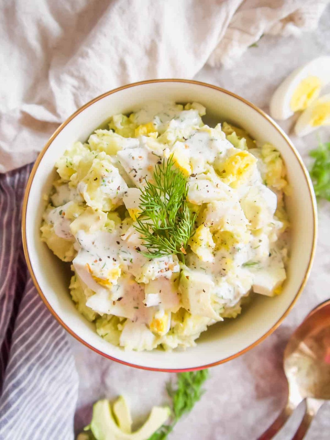 Dill Ranch Potato Salad with Avocado and Eggs in a bowl with fresh dill on top.
