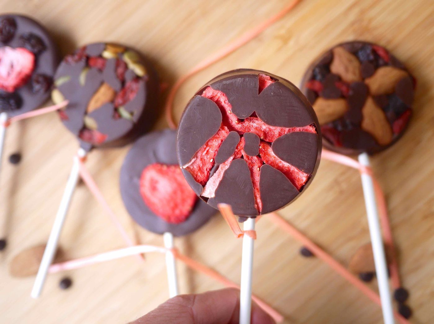 Dried fruit and nuts in a chocolate lollipop.