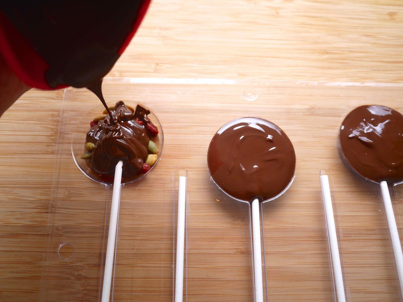 Pouring chocolate into the chocolate molds.