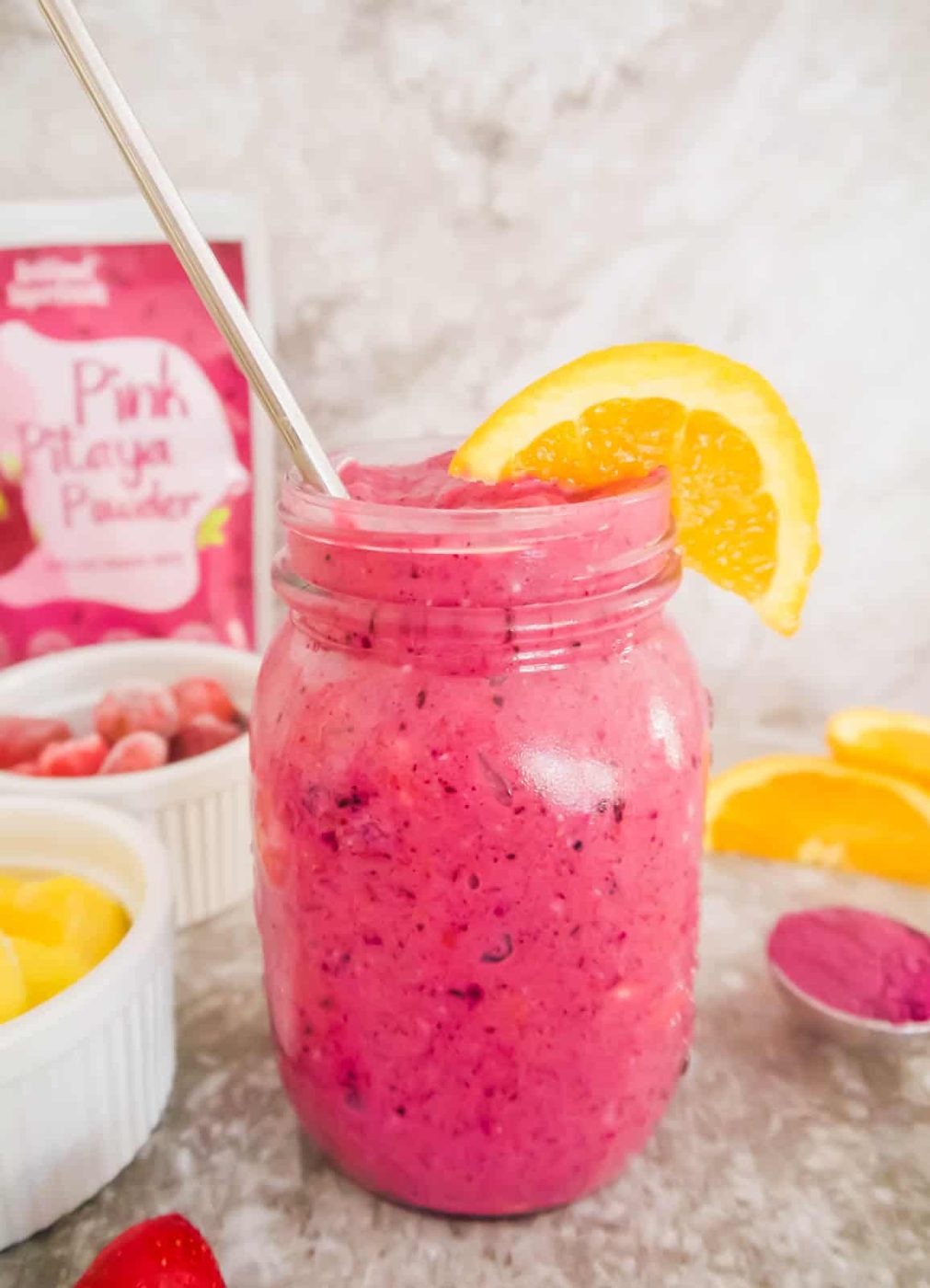 Mango dragonfruit smoothie in a mason jar.