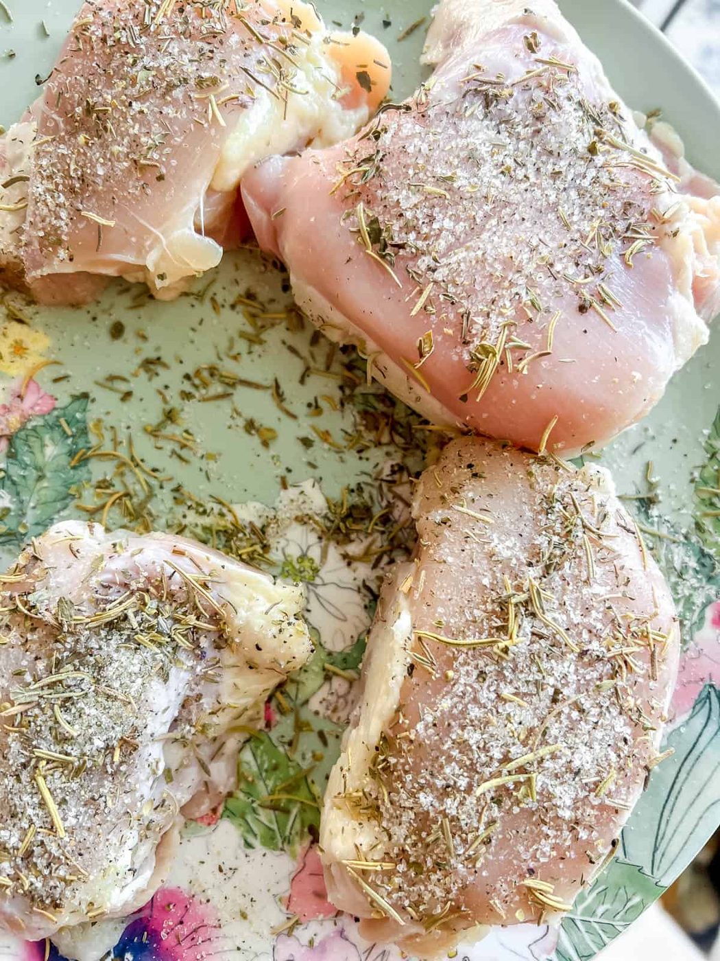 Chicken thighs with seasoning on it.