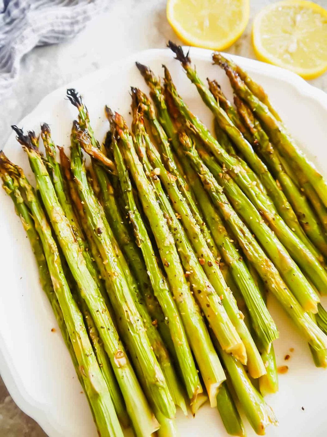 Asparagus with lemon freshly broiled and put on a plate.