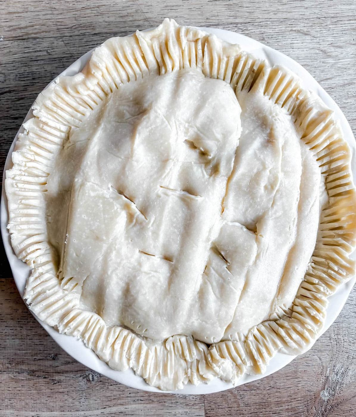 Top of pie crust added on top of veggie and chicken pot pie filling.