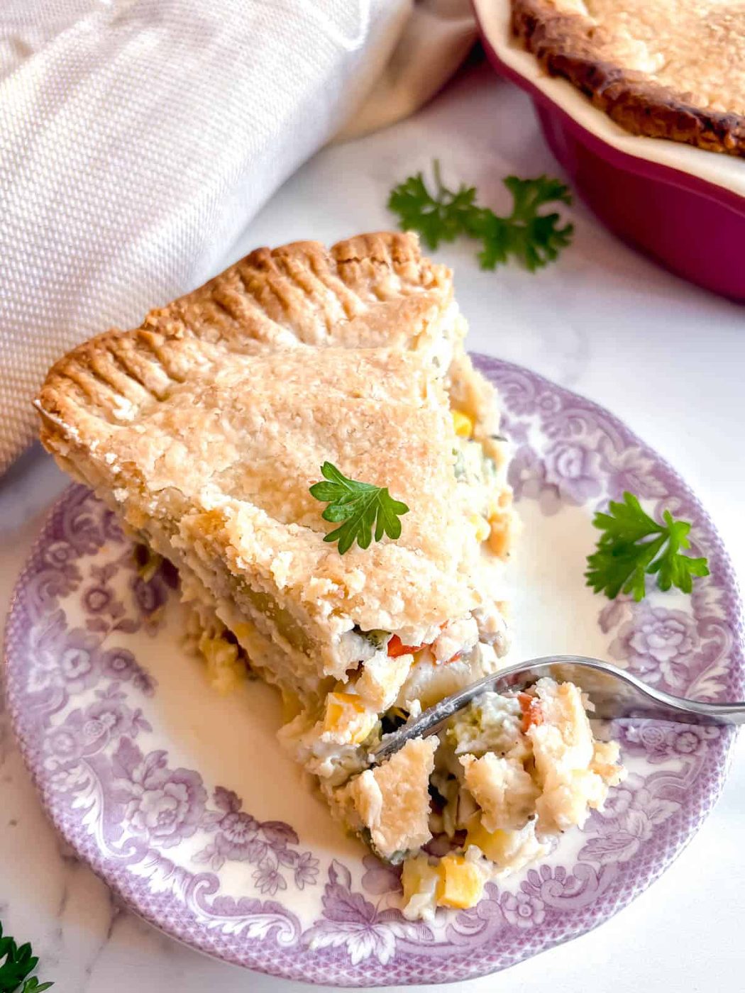 Fork going into a double crust chicken pot pie.