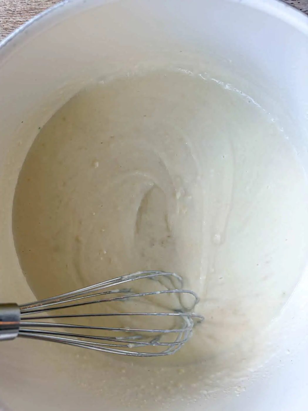 Milk added to the butter and flour to make the chicken pot pie sauce.
