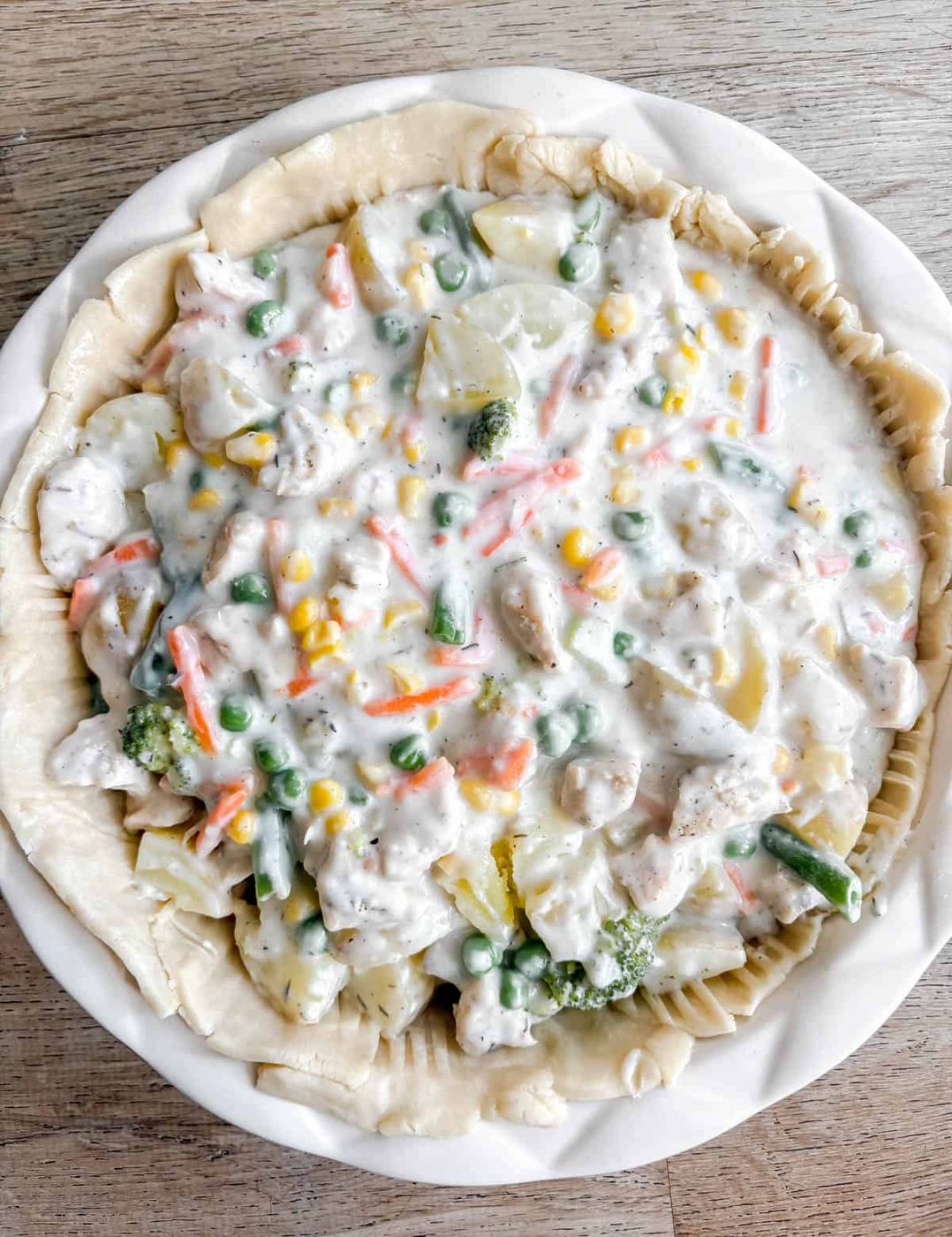 Pot pie sauce with veggies and chicken in the pie crust.