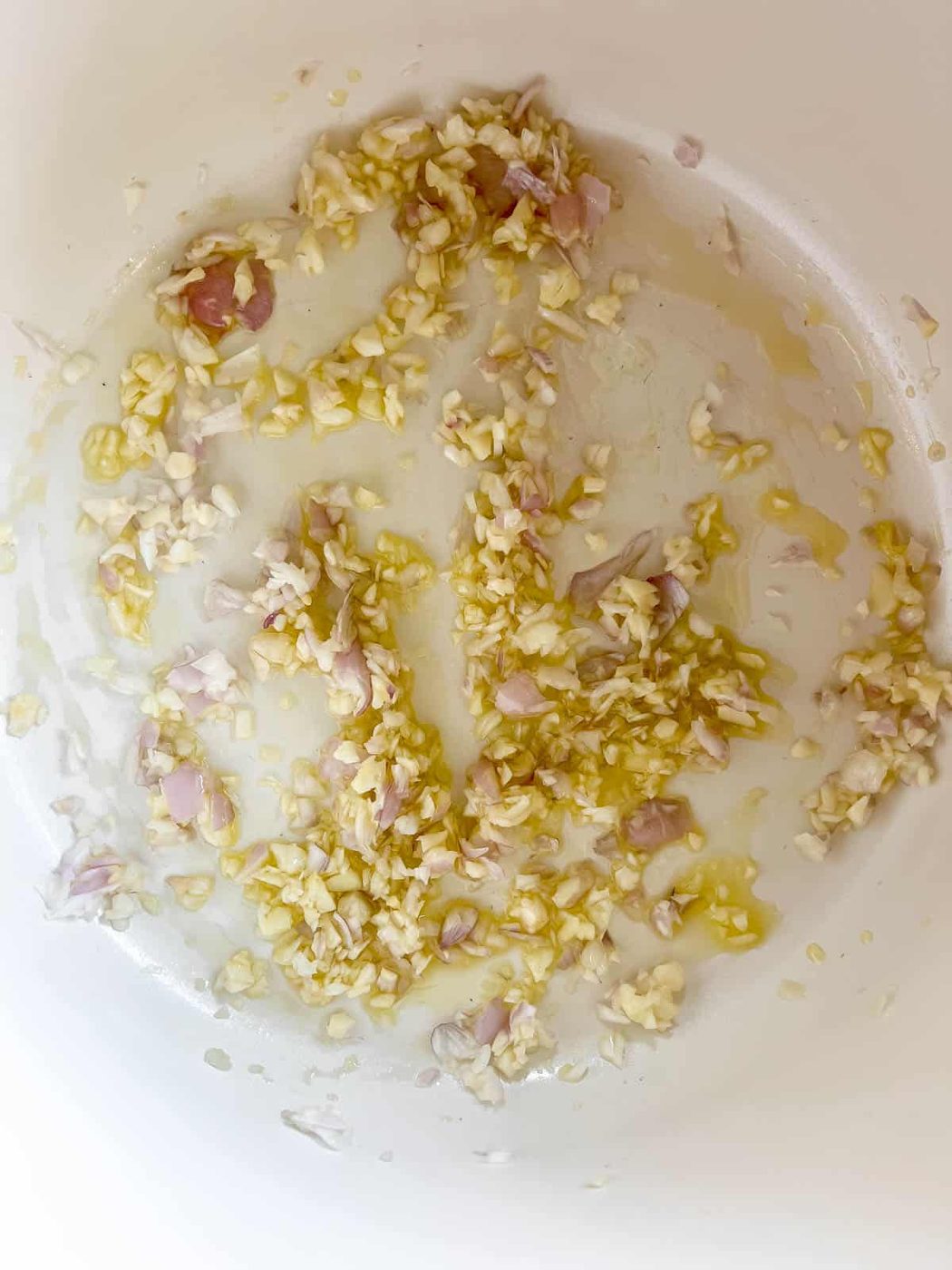 Sautéing shallot and garlic in a pan.