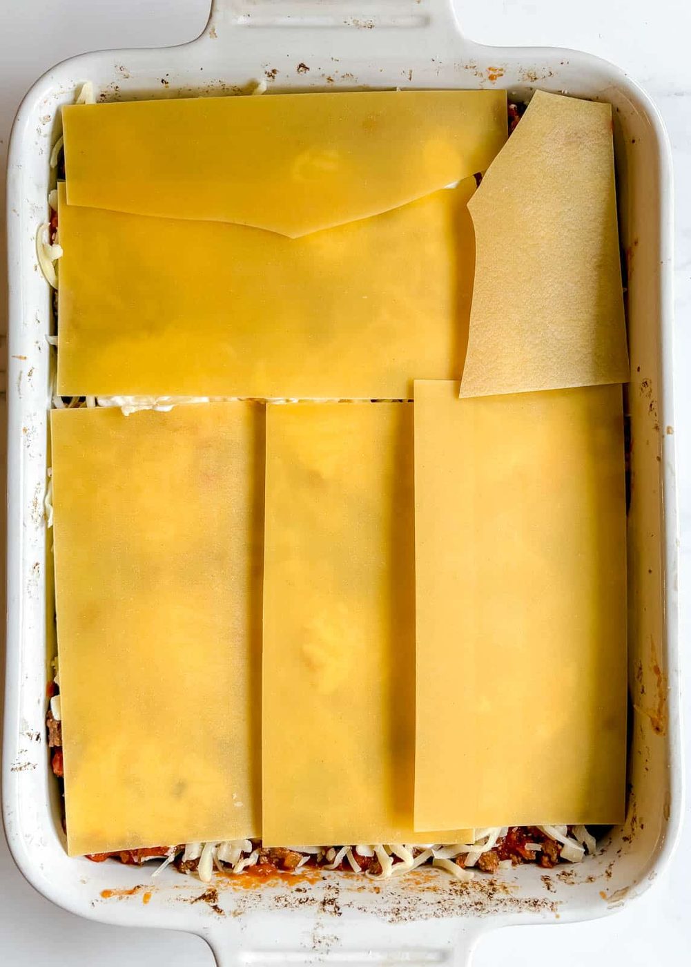 The last layer of no boil noodles added to the lasagna.
