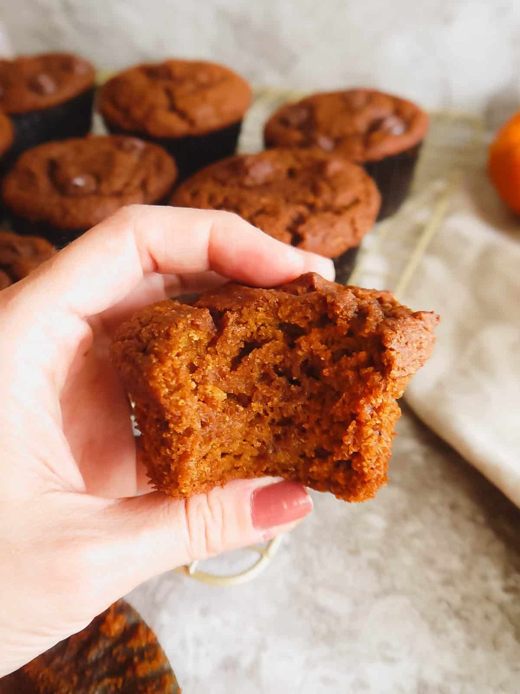 A bite taken out of a paleo pumpkin muffin.