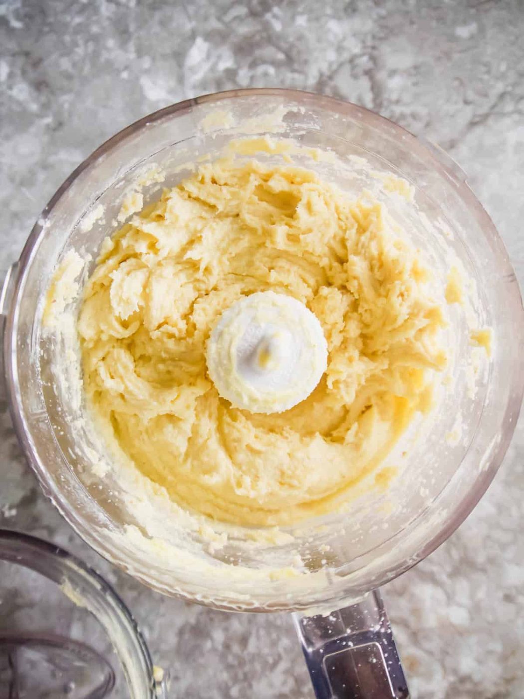 Paleo tart crust ingredients in the food processor after water and egg are added.