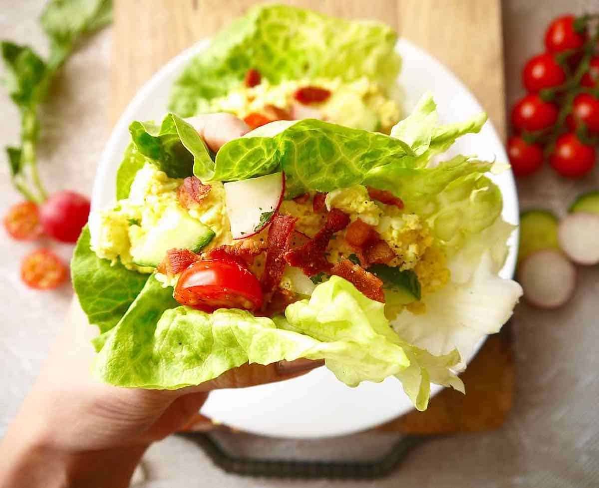 Egg salad wrap in hand.