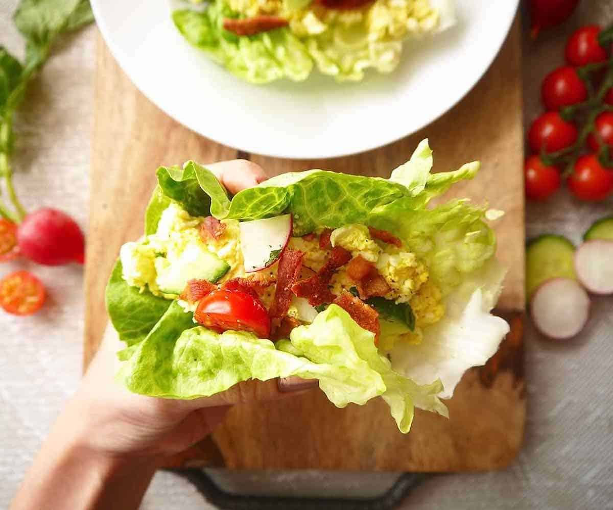 Egg salad wrap in someone's hands.