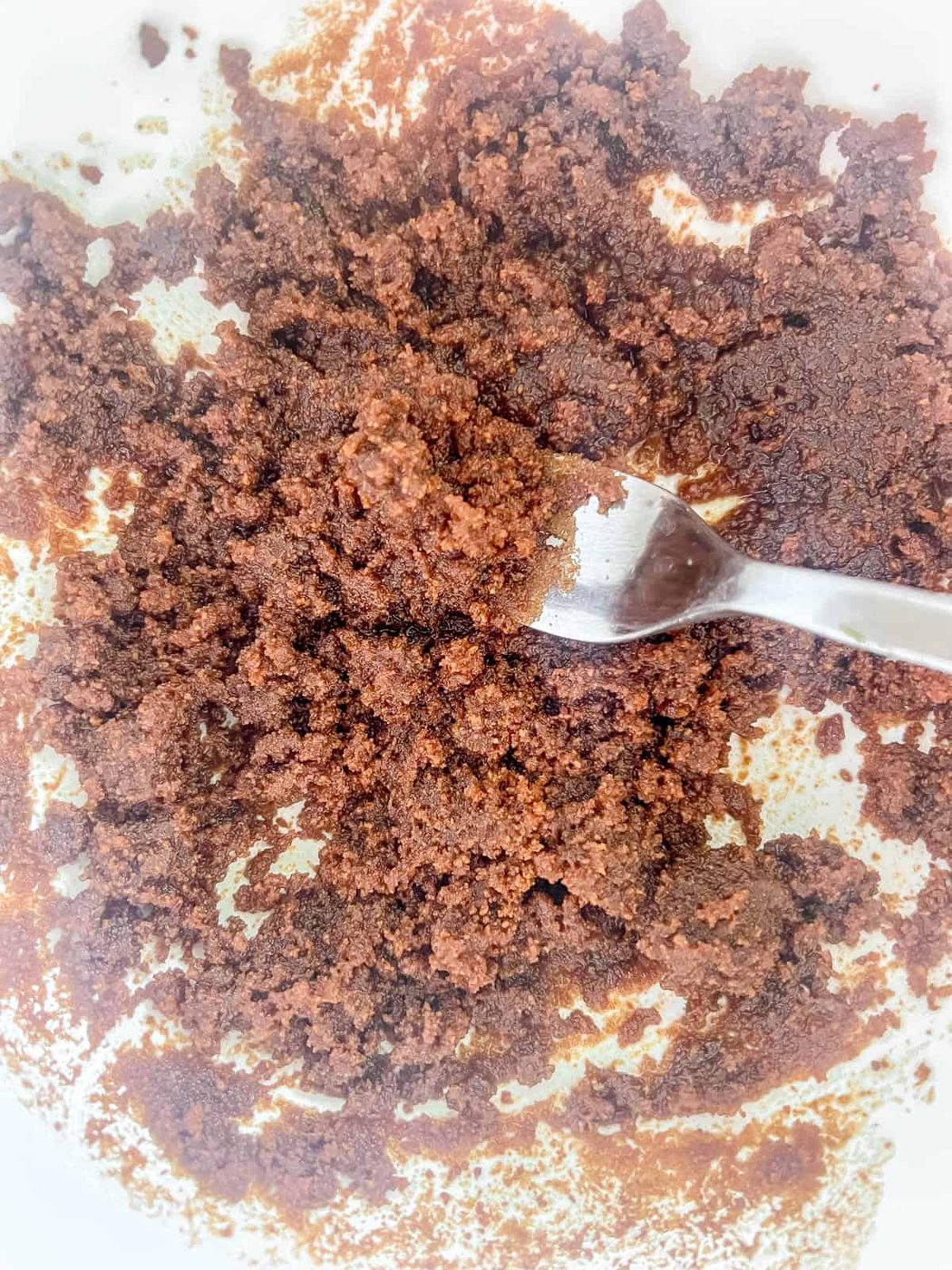 Coconut sugar mixed with oil in a bowl.