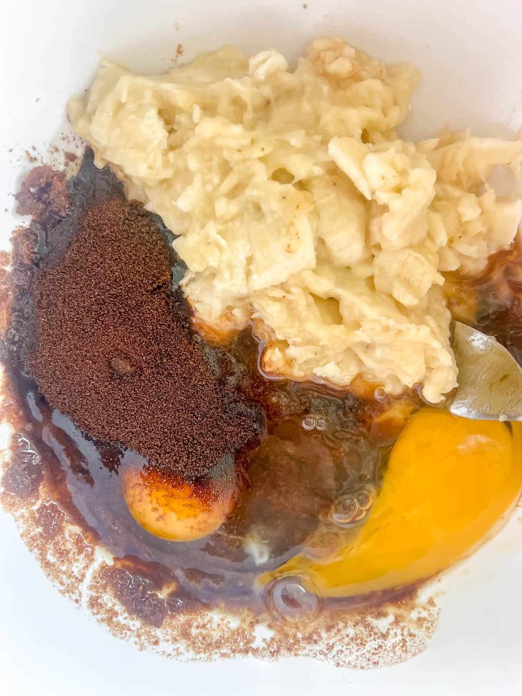 Wet banana bread ingredients in a bowl.