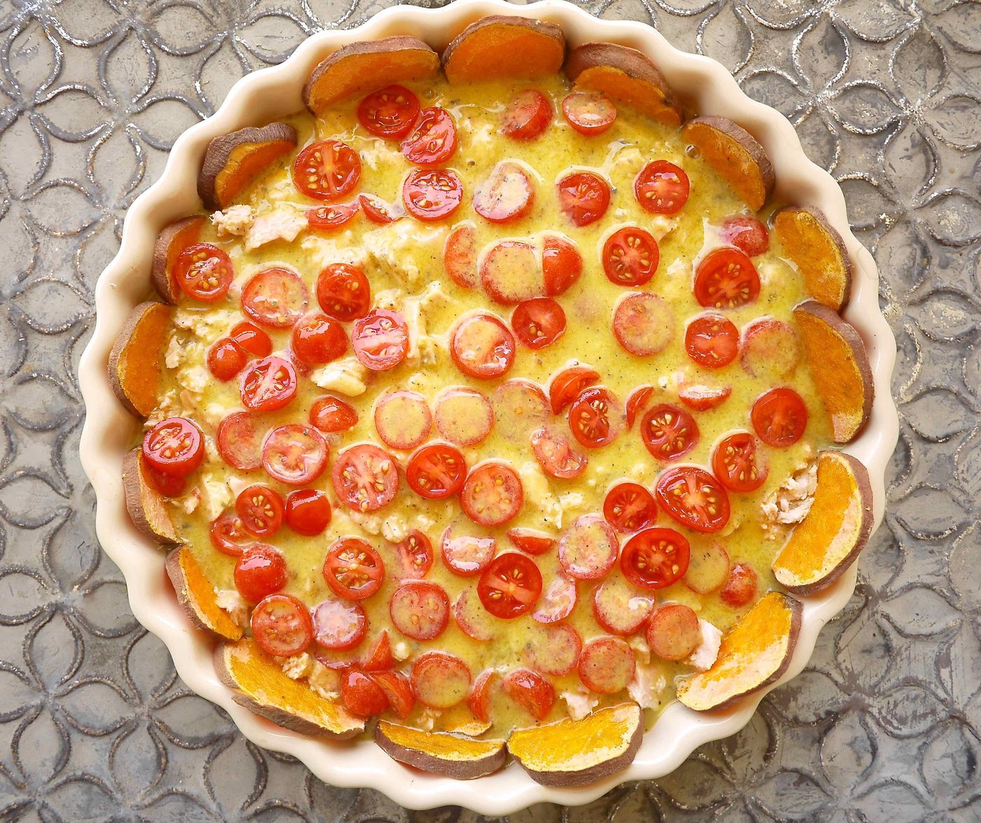 Quiche filling added to potato crust.