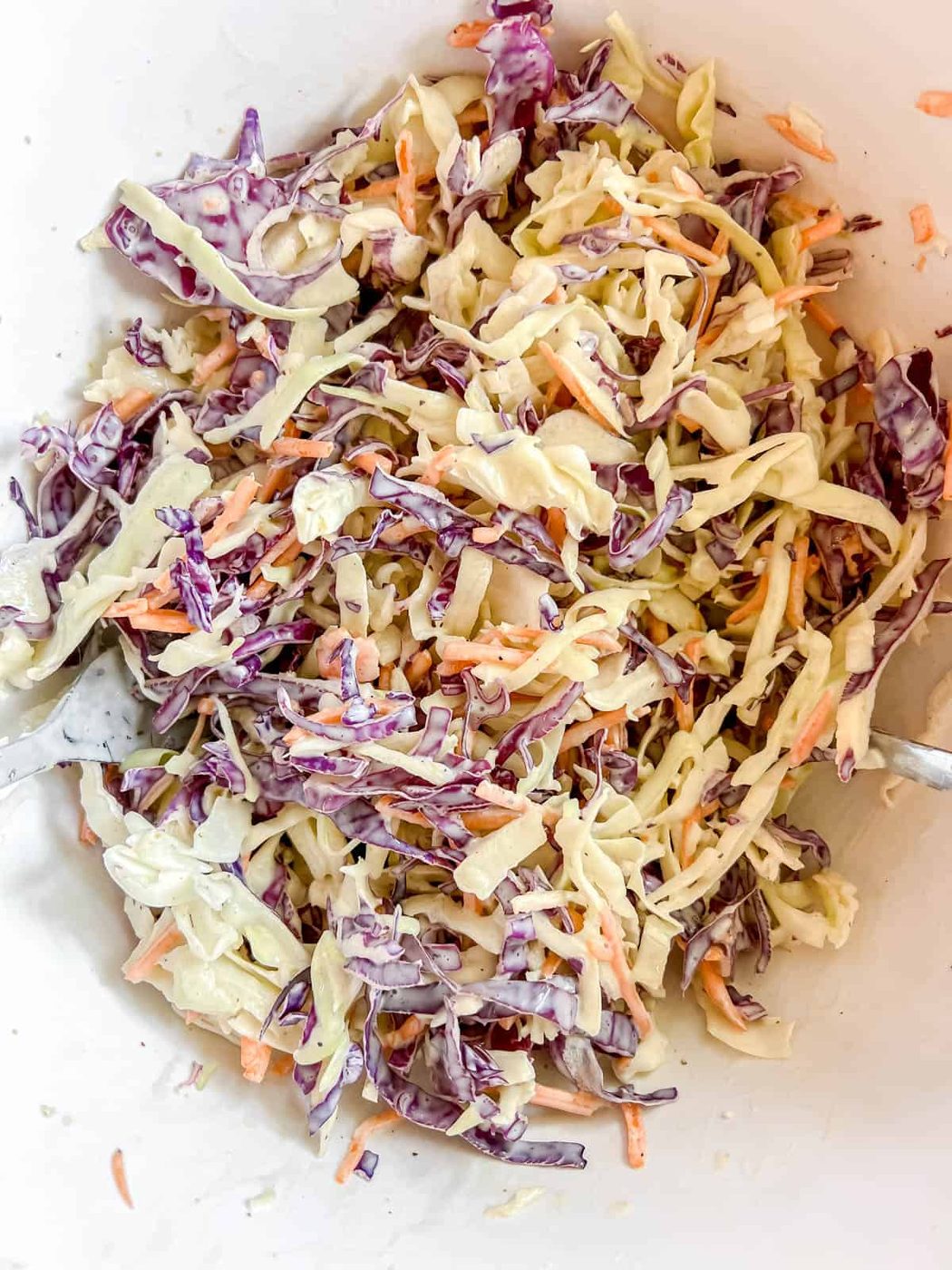 Dressing mixed into the cabbage and carrots.