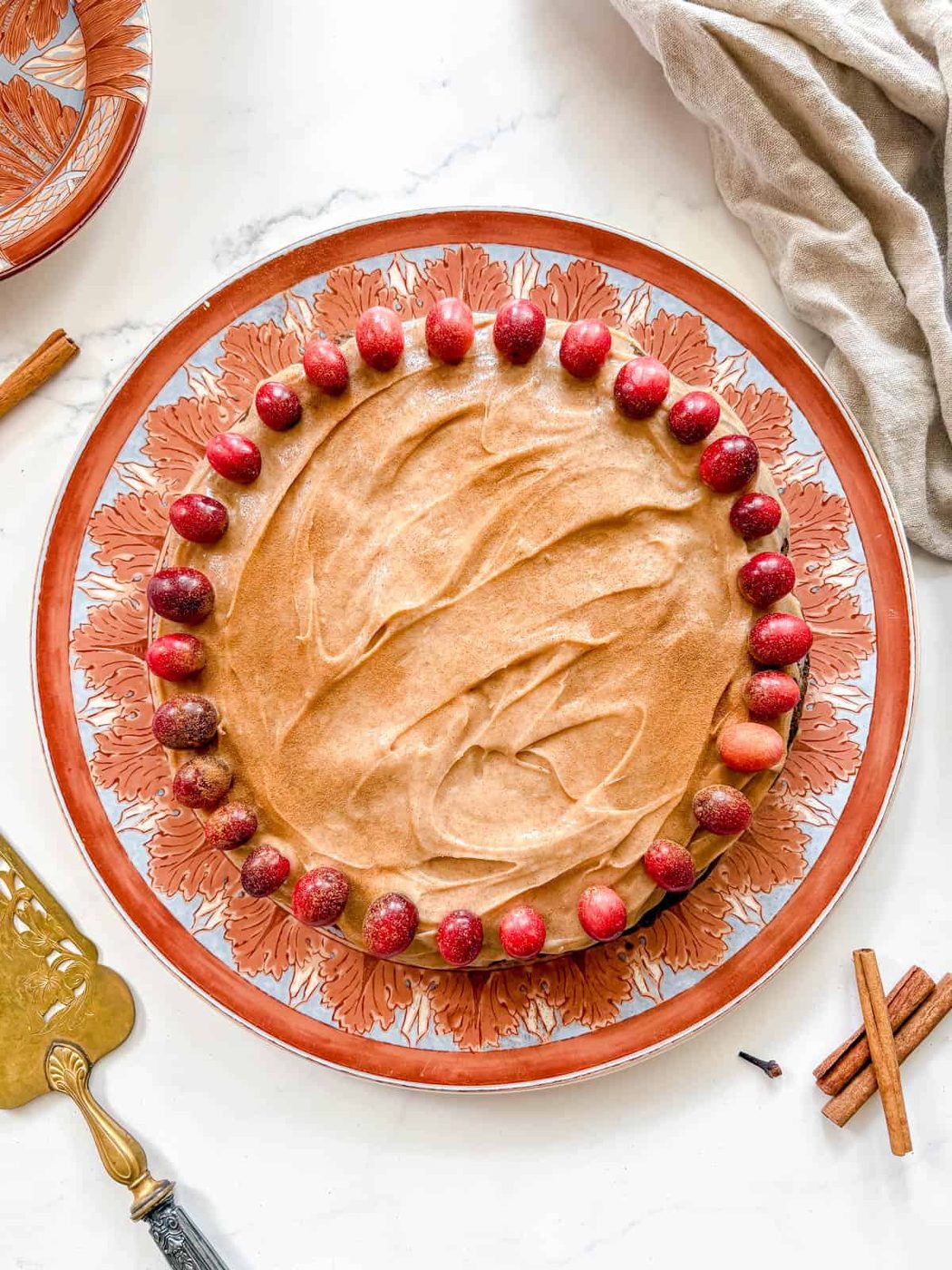 Gingerbread Cake with cream cheese frosting and cranberries on top.