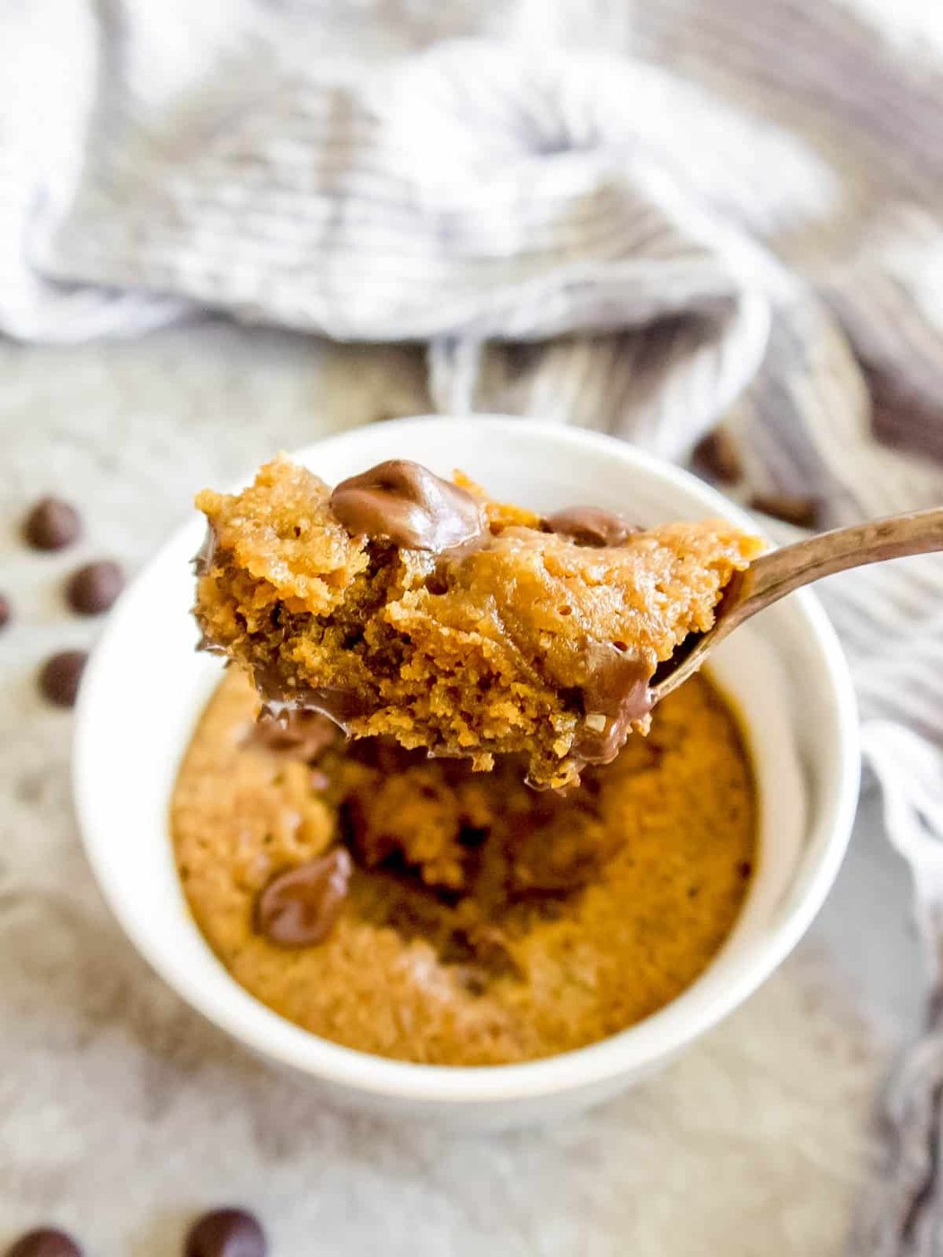 A bite of a paleo mug cookie on a spoon.