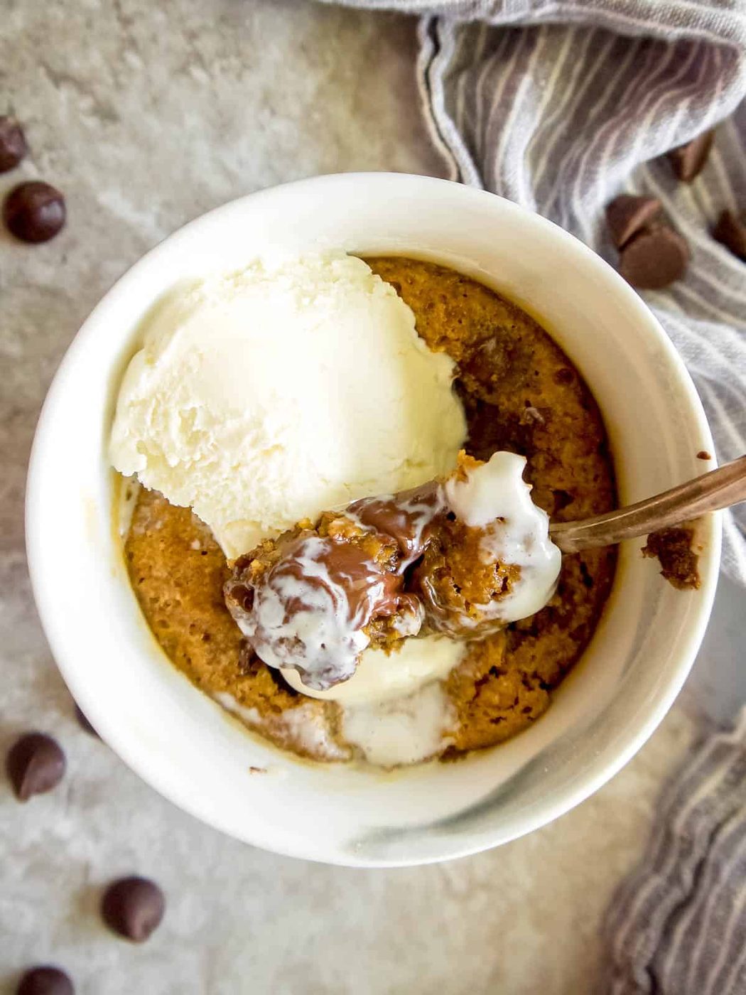 Lighter mug cookie with ice-cream on top.