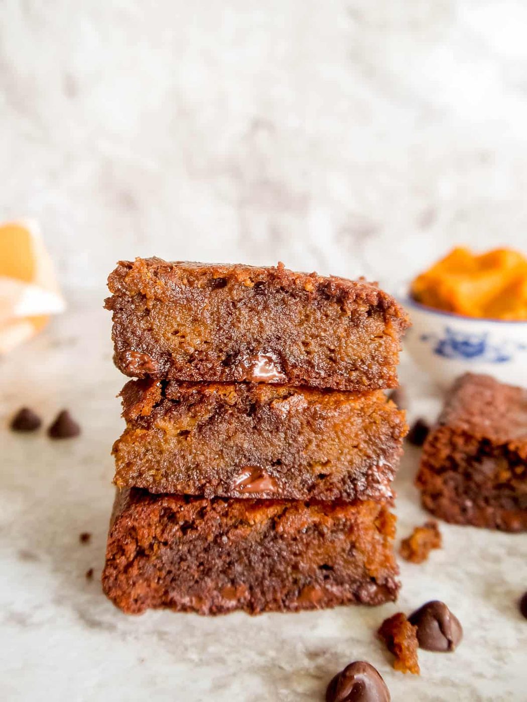 Paleo and gluten-free pumpkin swirl brownies stacked on top of each other.