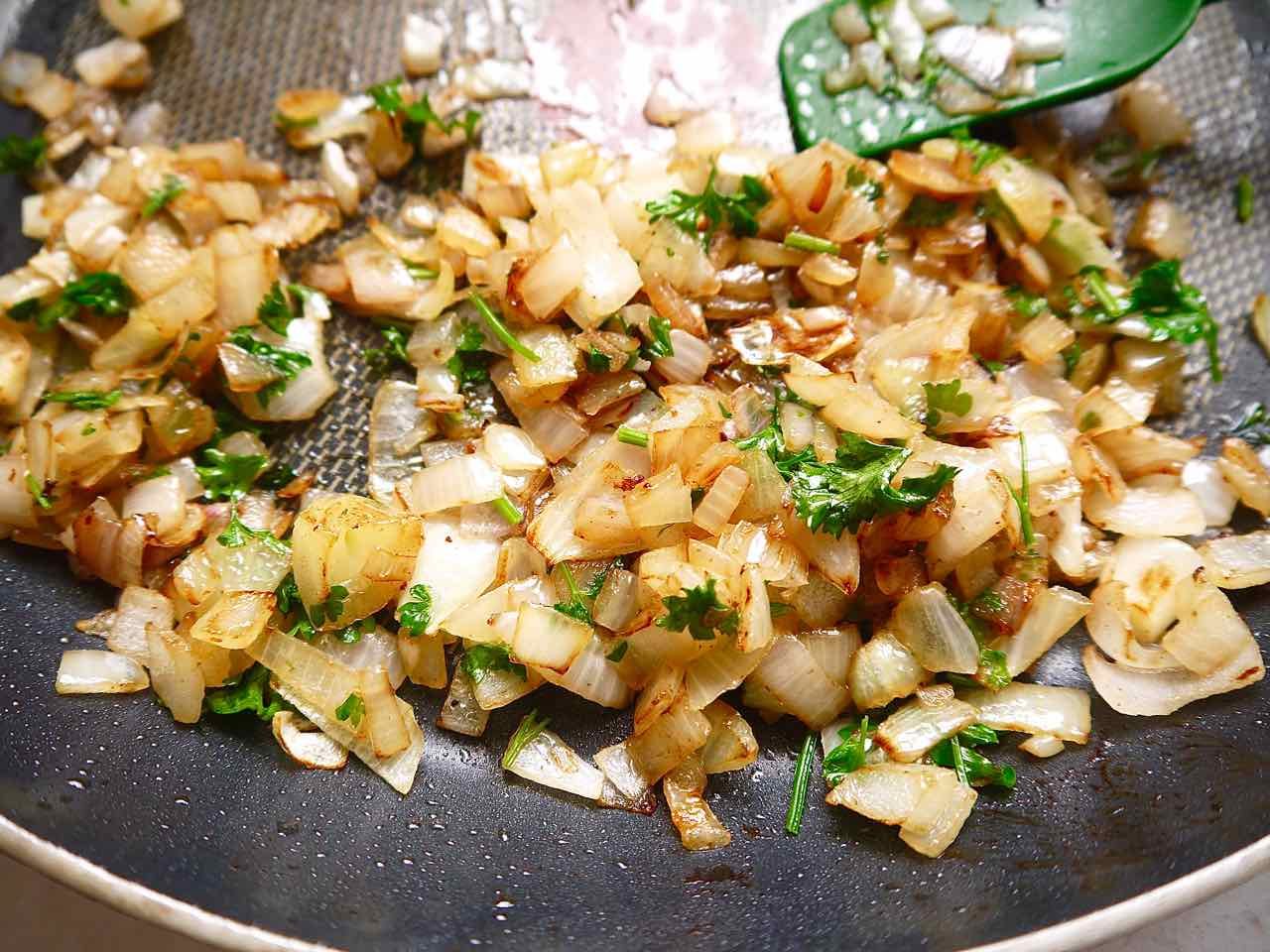 Parsley, onion and shallot in a pan.