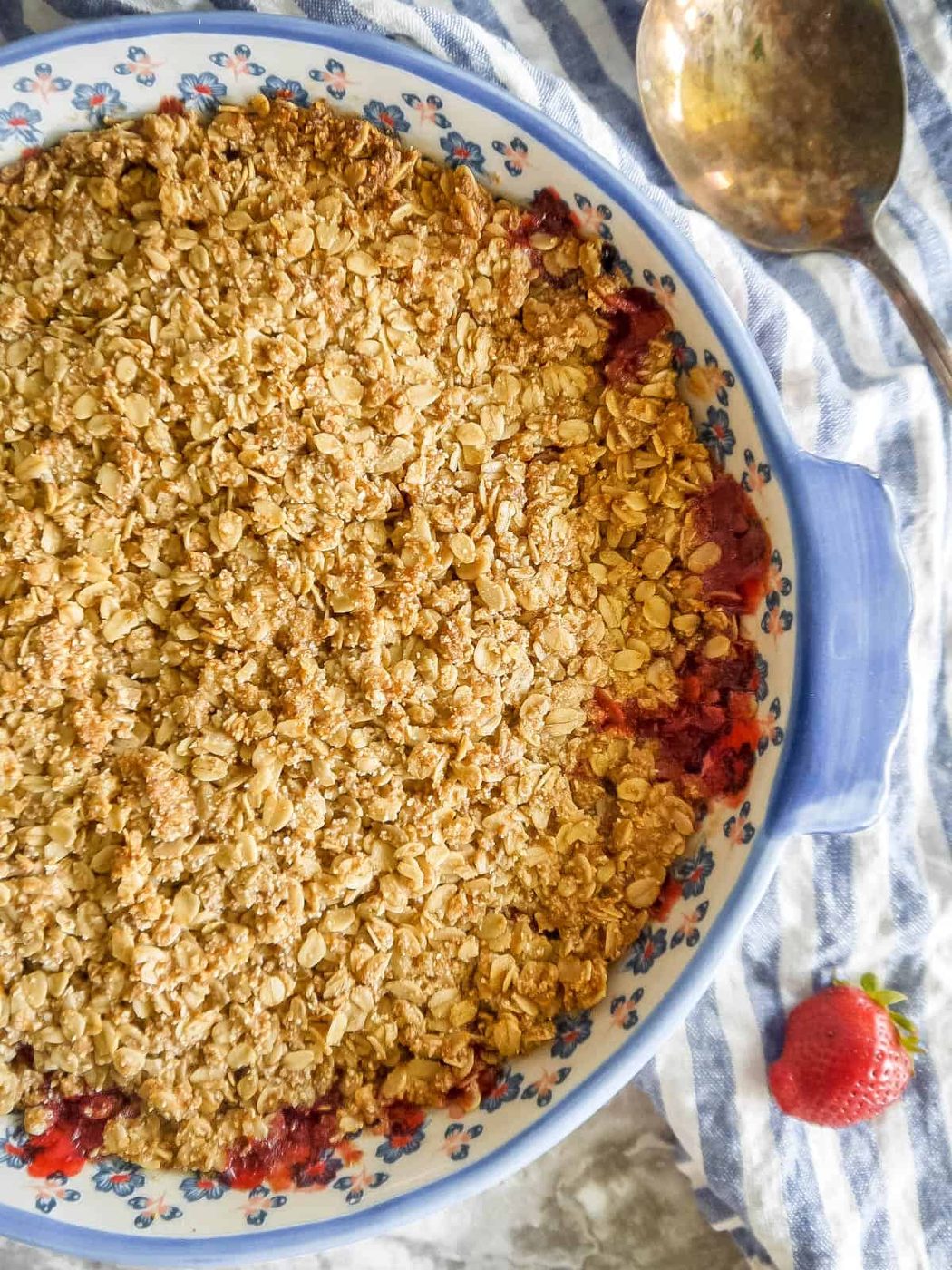 Freshly baked strawberry crisp in a baking dish.