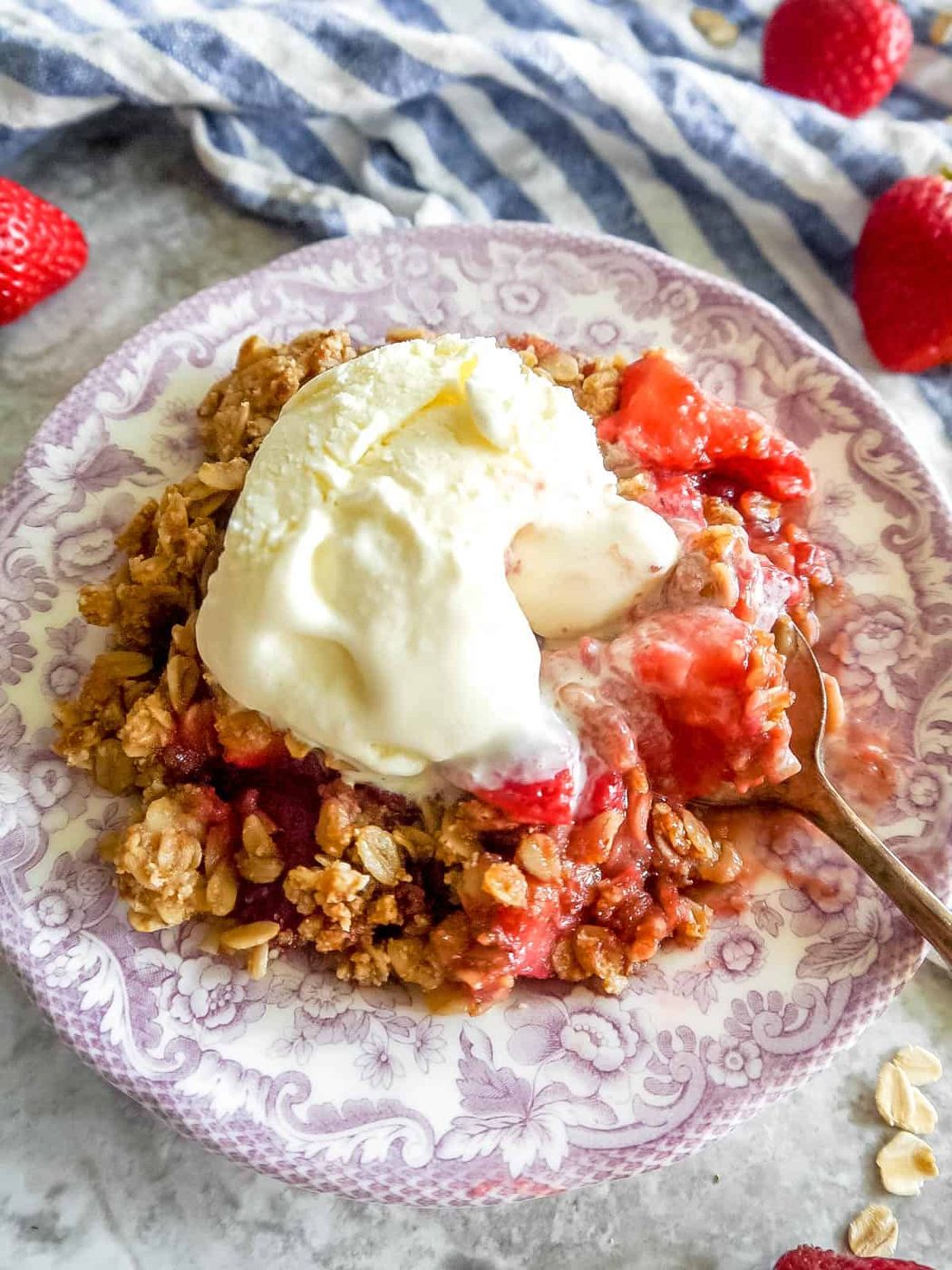 Fresh lighter strawberry crisp with ice-cream on top.