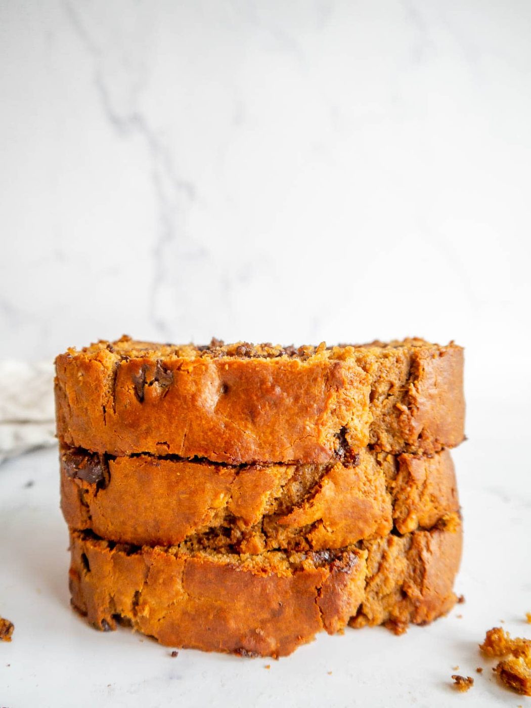 Slices of banana bread made with greek yogurt stacked on top of each other.