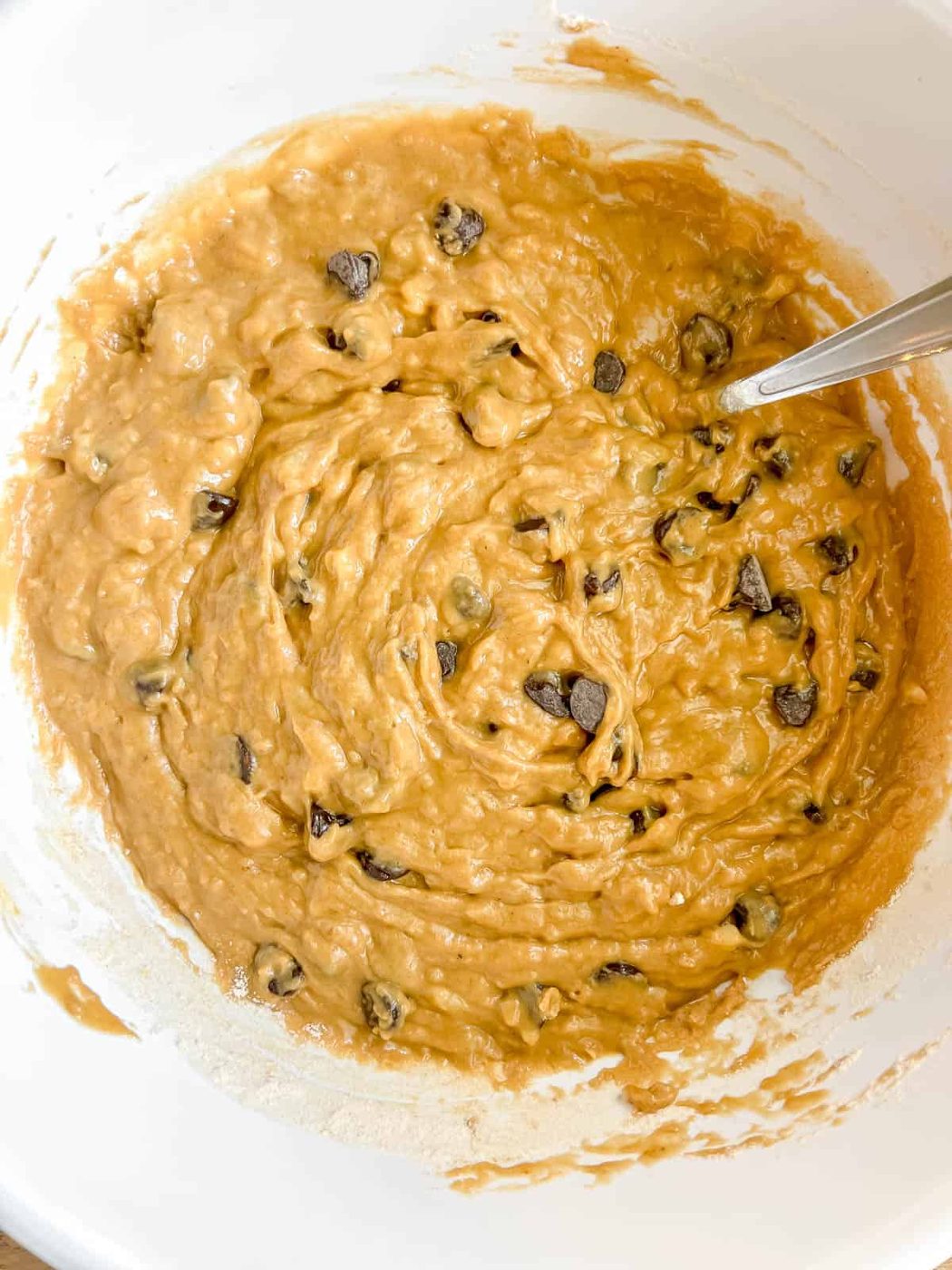 Batter for banana bread using greek yogurt and chocolate chips.