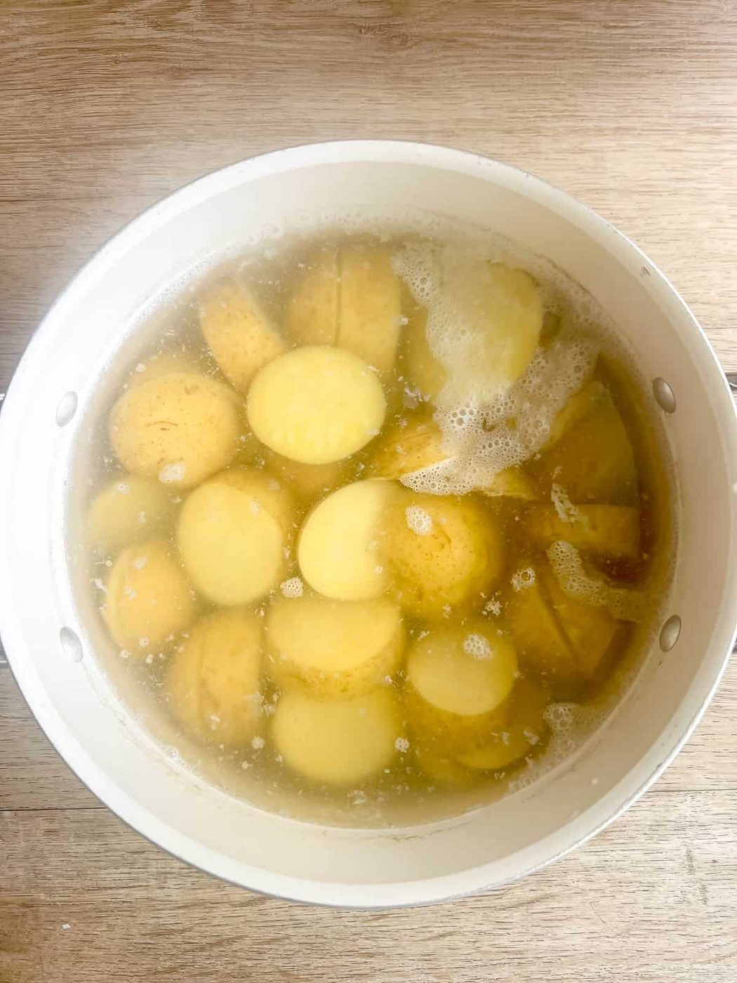 Potatoes in a pan boiling.