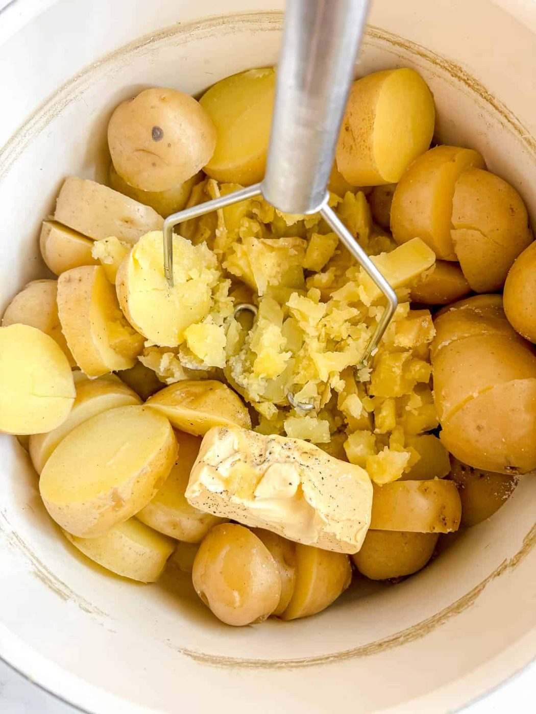 Potatoes ready to be mashed in a bowl.