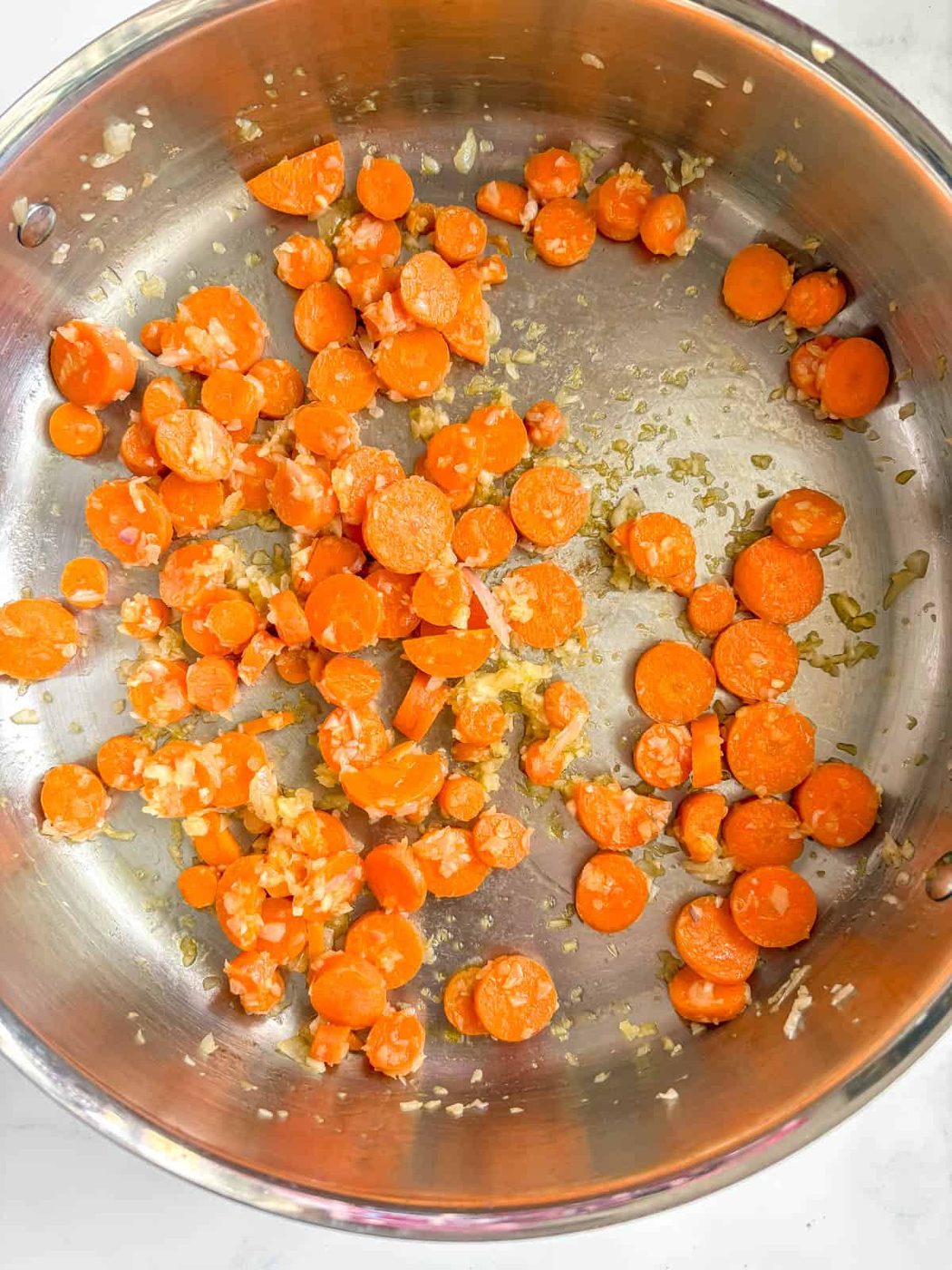 Garlic, onion and carrots in a pan.