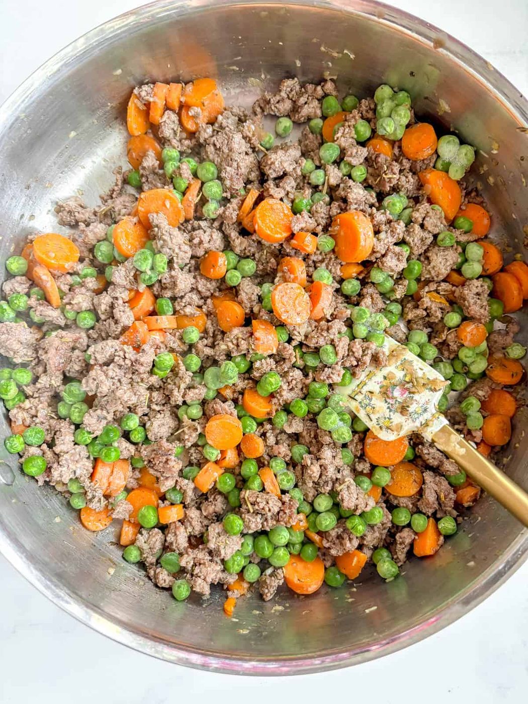 Peas and flour added to the ground beef.
