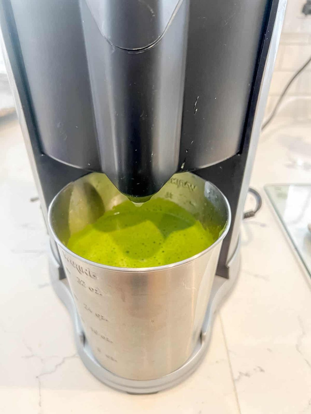 Green lemonade in a juicer.