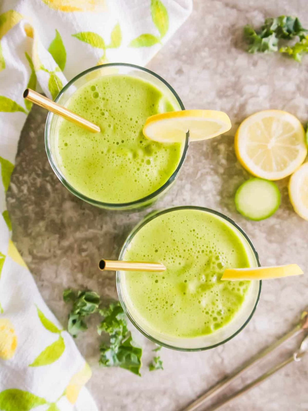 Kale apple cucumber lemon juice in two glasses.