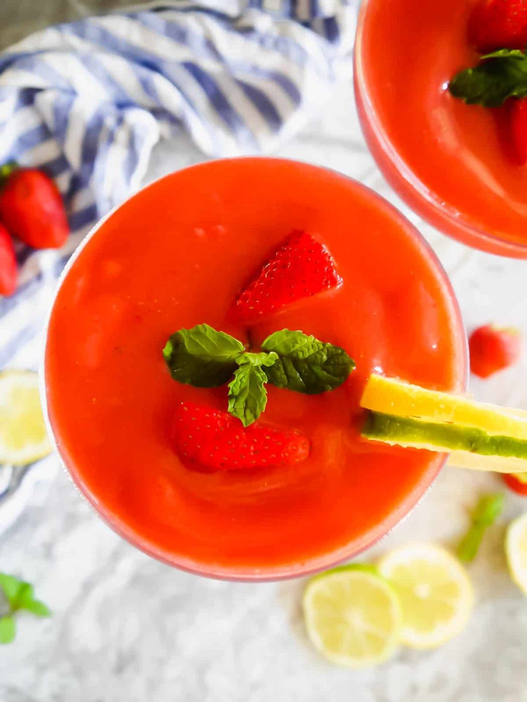 Aerial view of a lighter strawberry daiquiri in a glass.
