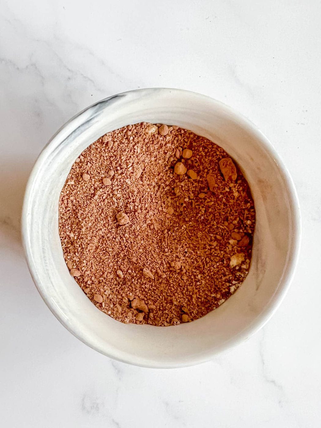 Dry ingredients in a ramekin to make a lighter brownie in a mug.