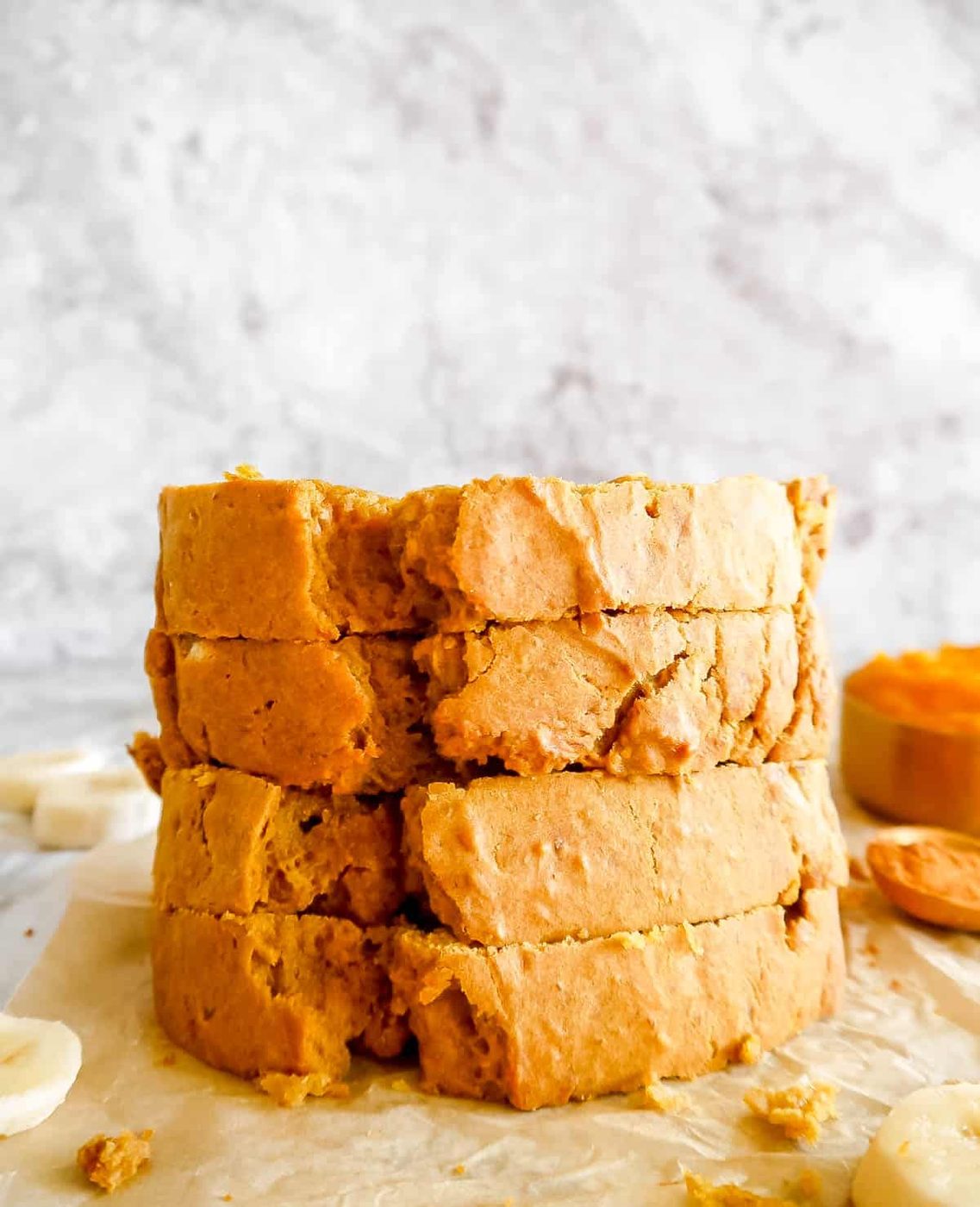 Stacked slices of pumpkin banana bread.