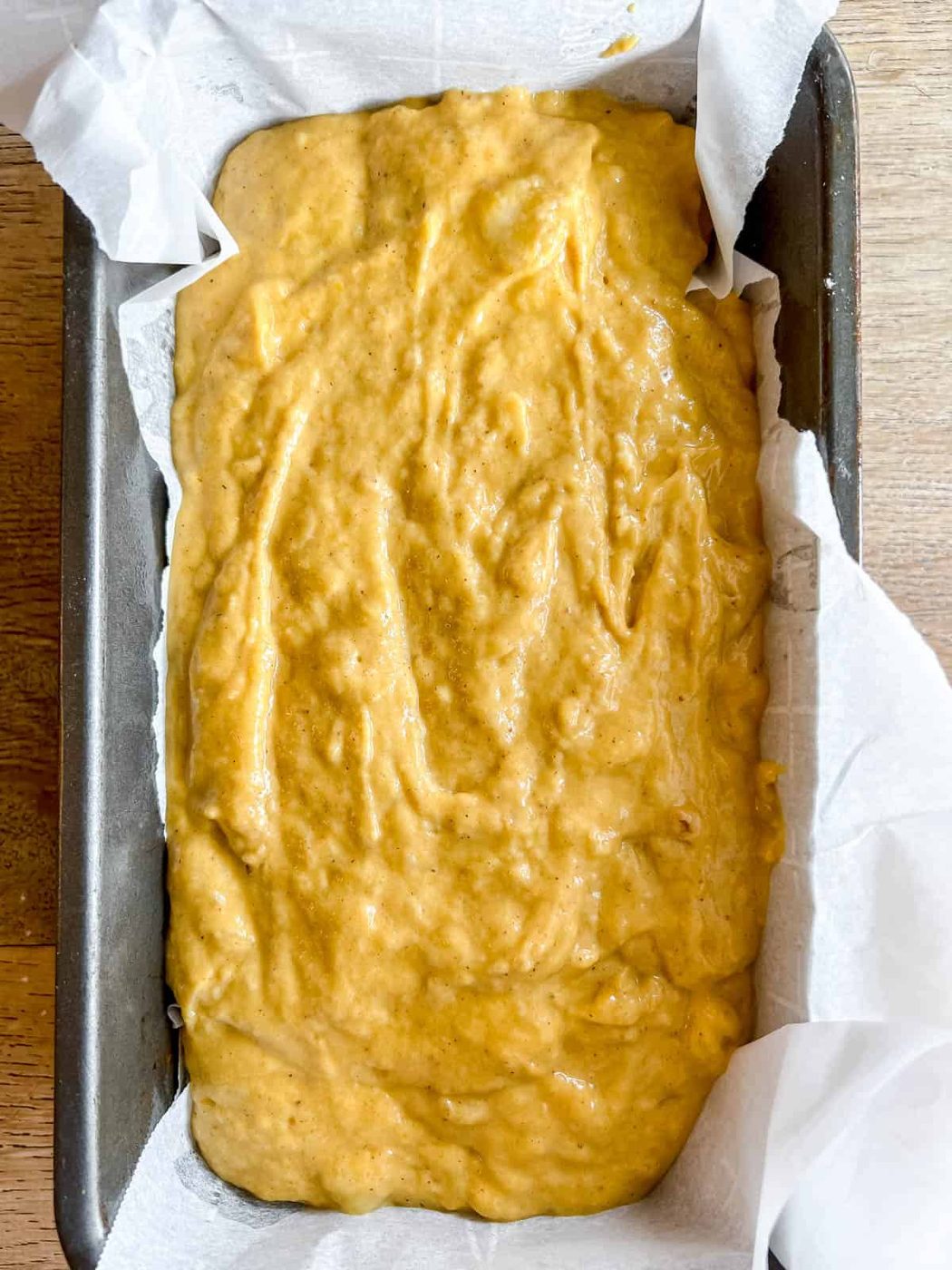 Pumpkin banana bread batter in a loaf tin before baking.