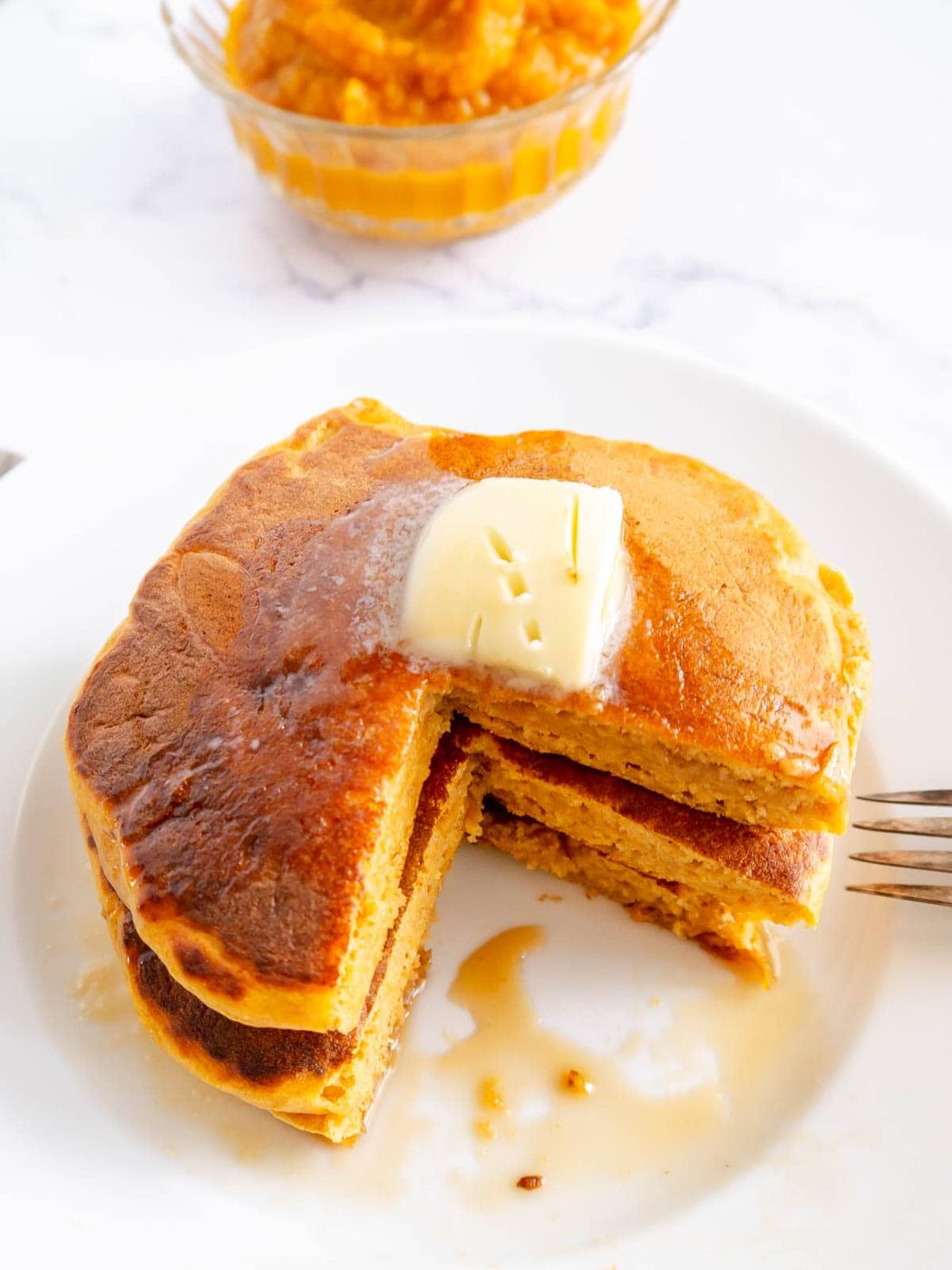 Pumpkin greek yogurt pancakes stacked on top of each other.