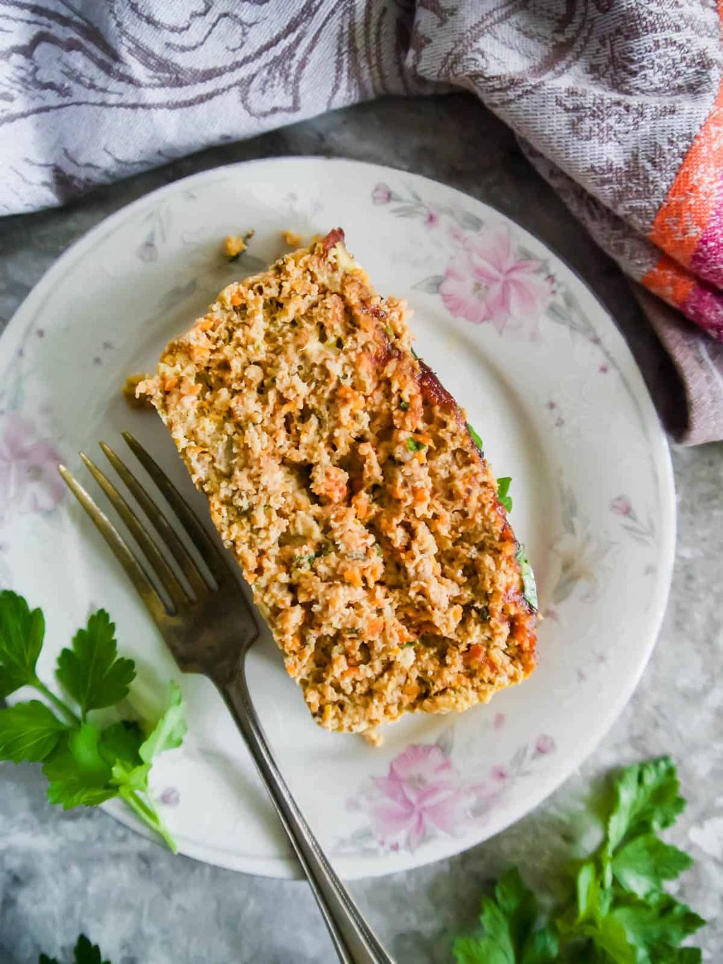 A slice of Lighter Ground Chicken and Turkey Meatloaf on a plate.