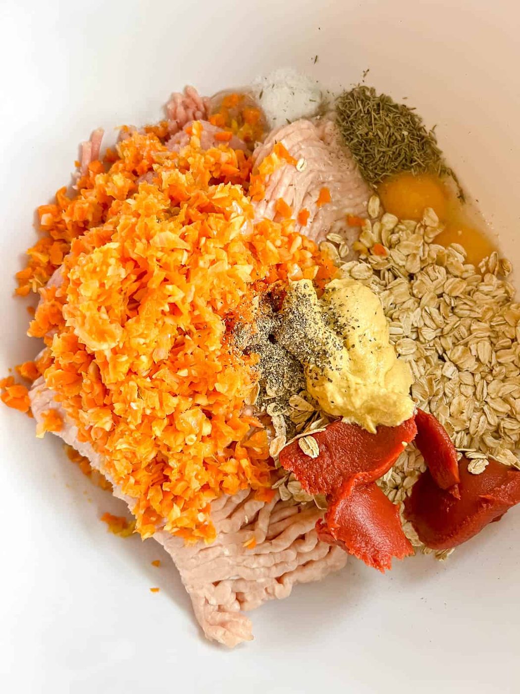 All the meatloaf ingredients in a bowl.