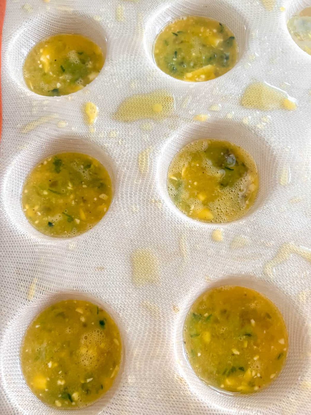 Egg mixture in silicone muffin tin.