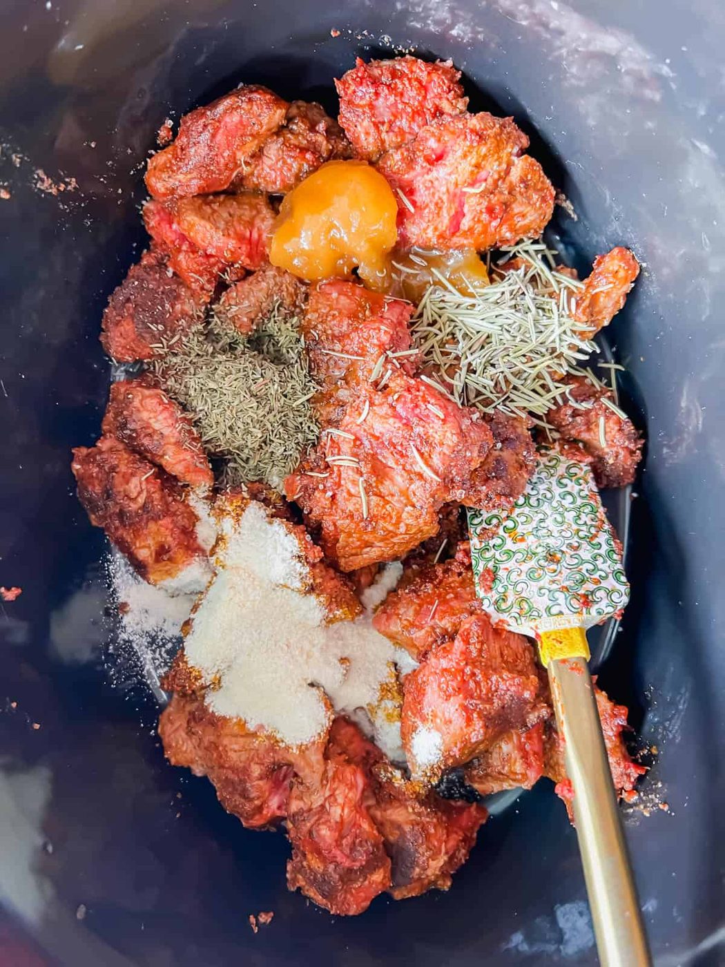 Stew meat and seasoning in the crockpot.