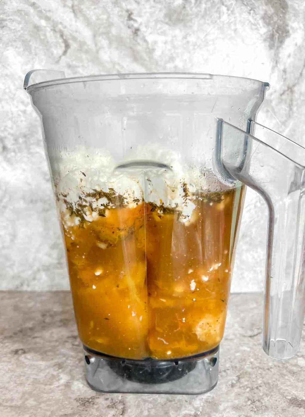 Bone broth butternut squash soup ingredients in a blender.