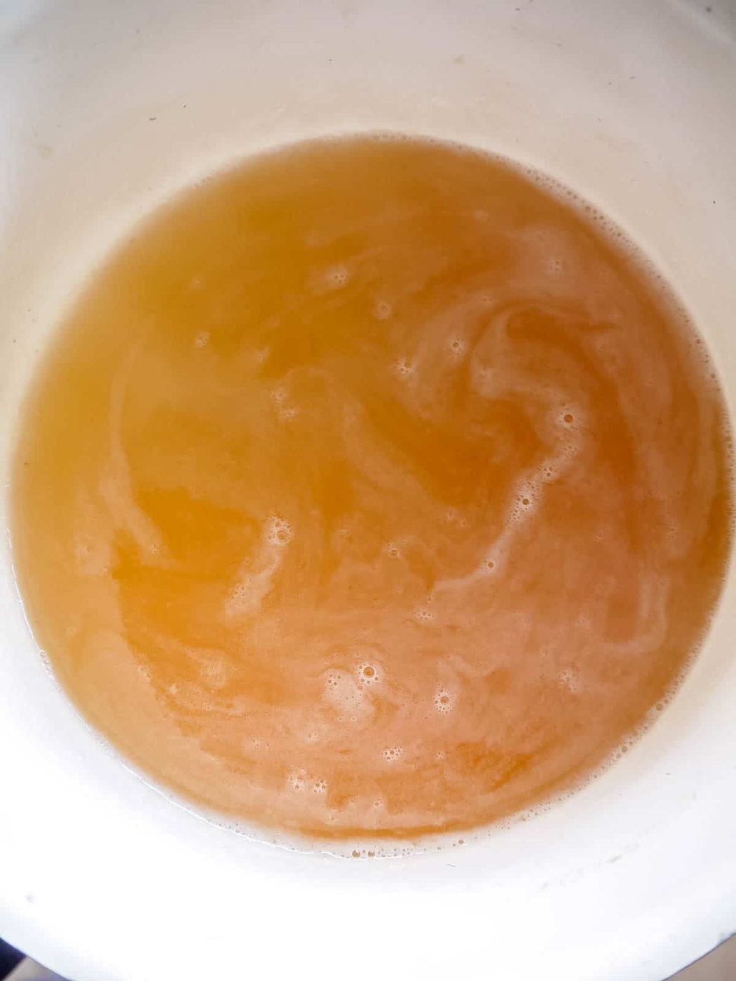 Apple juice heating in pan.