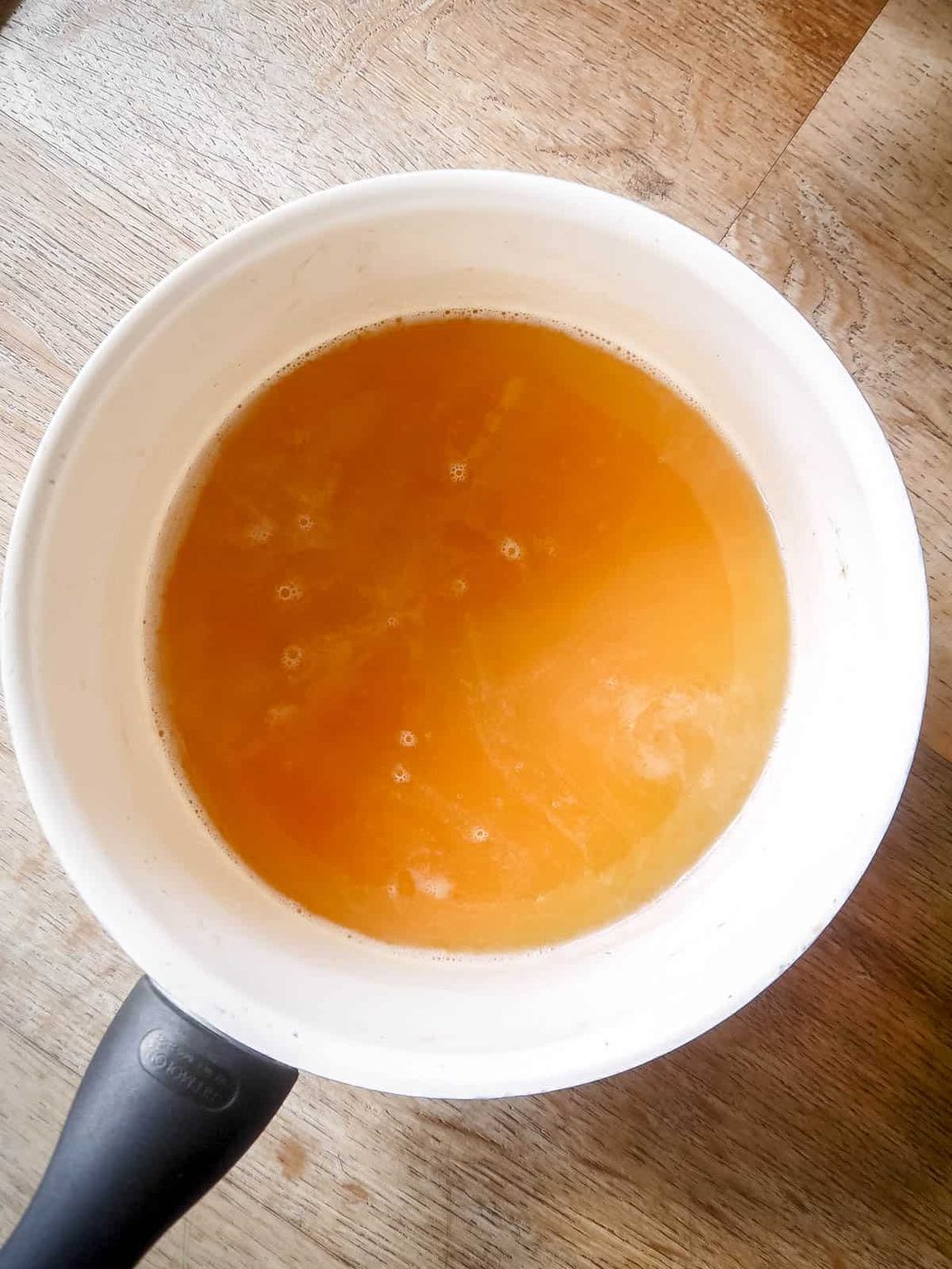Gelatin mixed into apple juice.